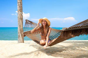 Vivacious beautiful woman in hammock smiling