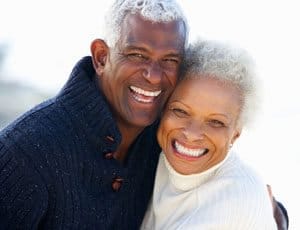 Happy old couple smiling and hugging