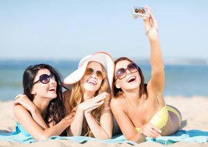 Girls taking self photo on the beach